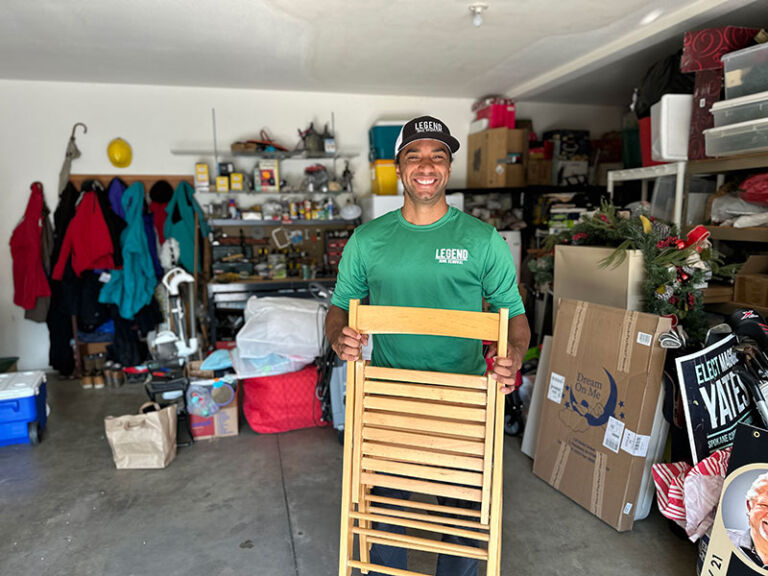 Legend Junk Removal crew holding unwanted furniture